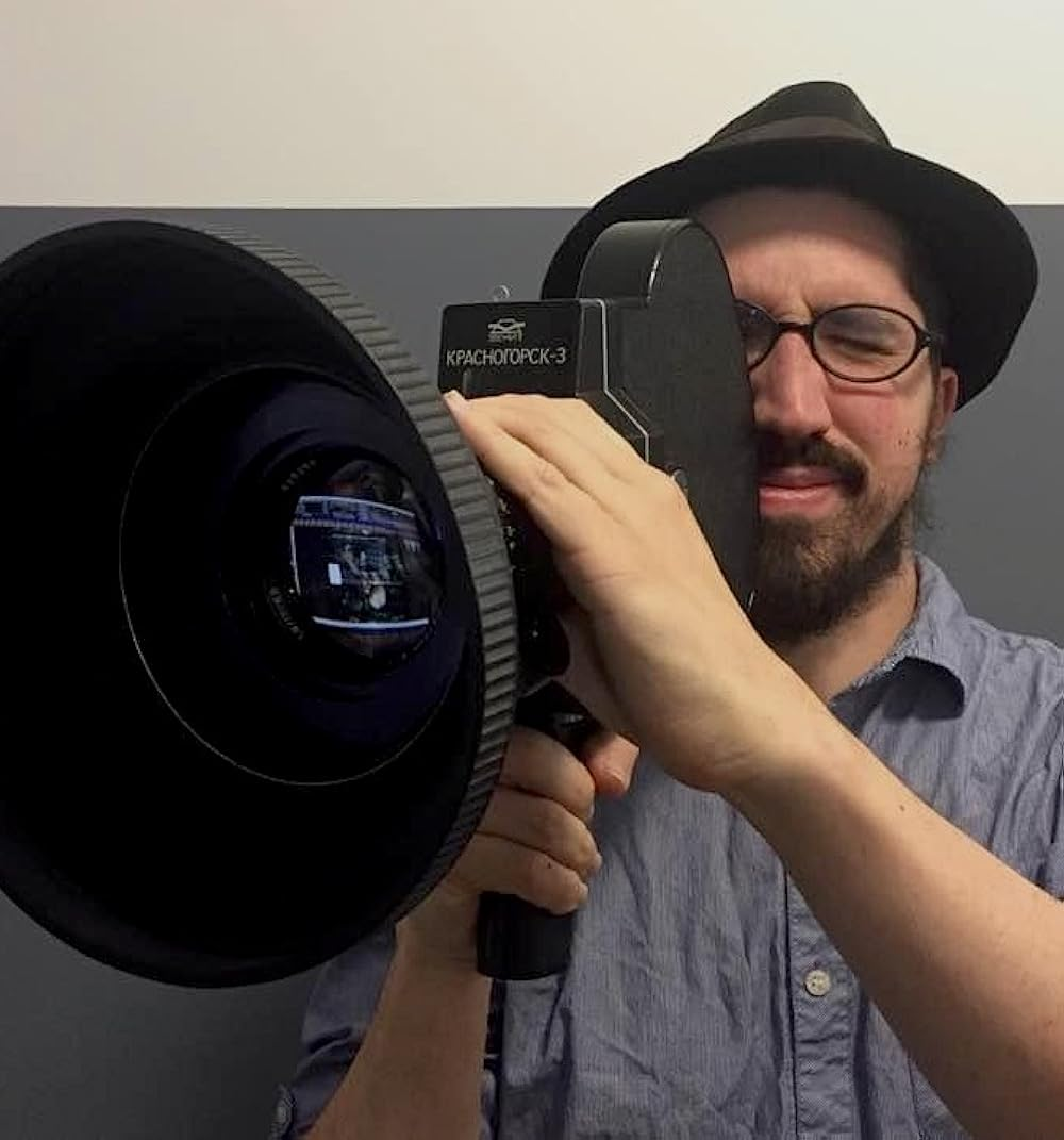 Daniel Kremer operating a film camera.